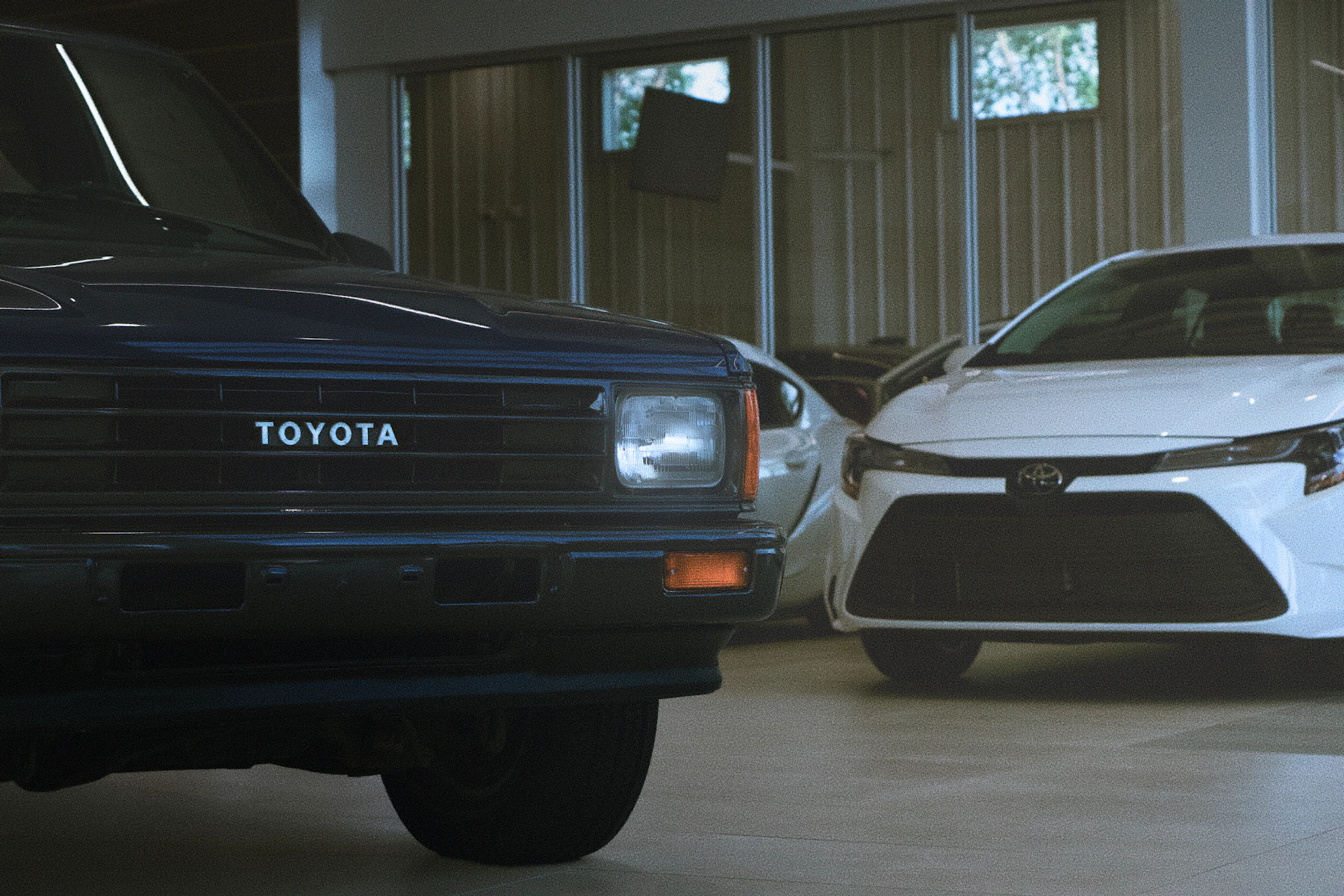 Classic and modern cars parked indoors