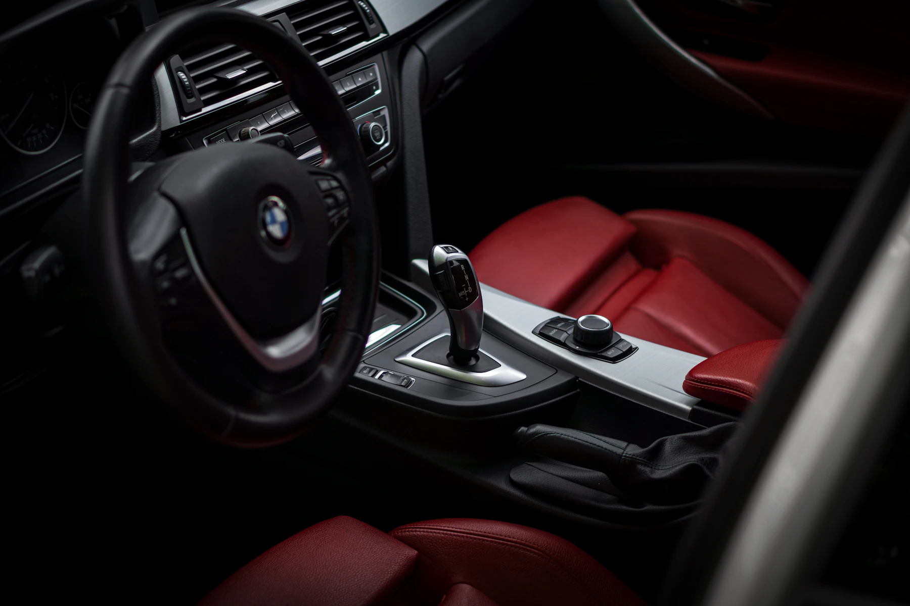 Black car interior with red leather seats