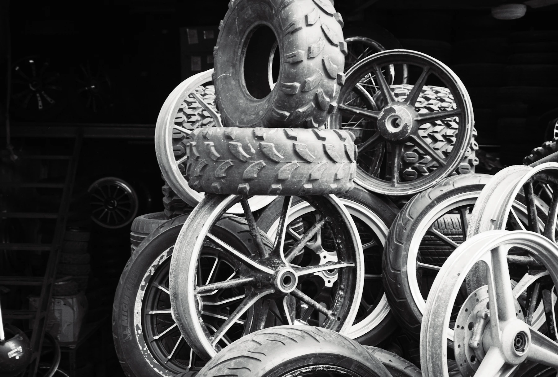 Pile of various tyres and wheels stacked together